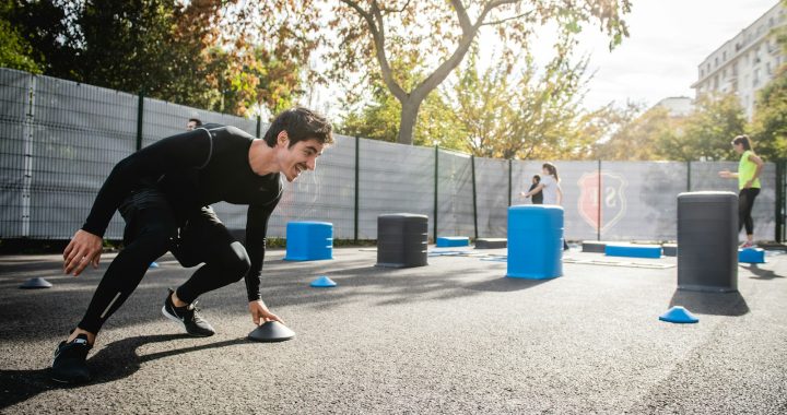 boy in black long sleeve shirt and blue pants playing with blue plastic container during daytime